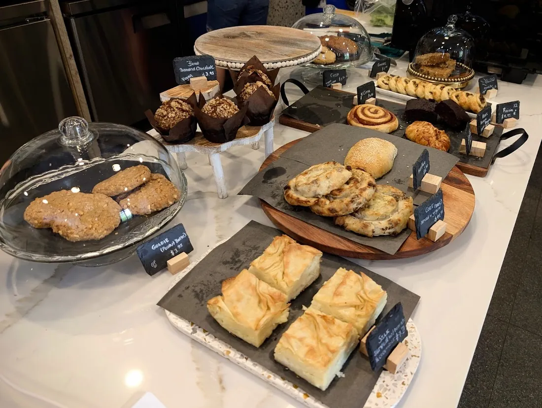 Trays of golden pastries and börek on the Café Miracle counter, with the café’s tables and chairs behind
